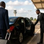 Business traveller being welcomed by a professional chauffeur during an executive airport transfer in Kenya.